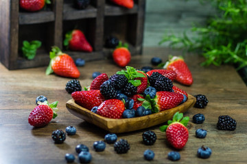 Mix Berries strawberries, blueberries, blackberries on Wooden Background. Summer Organic Berry over Wood. Agriculture, Gardening