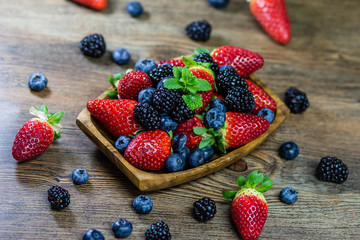 Mix Berries strawberries, blueberries, blackberries on Wooden Background. Summer Organic Berry over Wood. Agriculture, Gardening