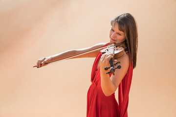 Woman in a red dress playing violin.
