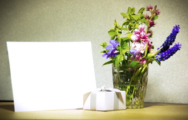 Blank card, present and flowers