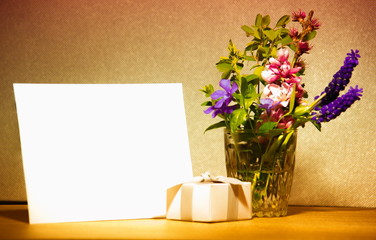 Blank card, present and flowers