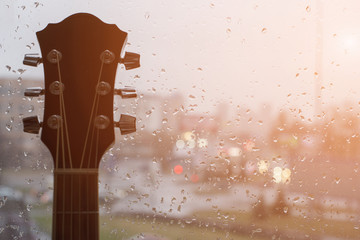Rain stained window background with a guitar