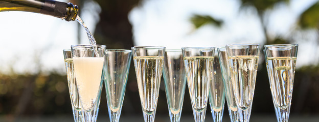 Many glasses of champagne or prosecco near resort pool in a luxury hotel. Pool party. © Ekaterina_Molchanova