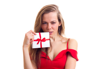 Fototapeta premium Young woman in red dress holding present