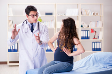 Doctor examining pregnant woman patient