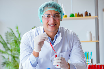 Young doctor working on blood test in lab hospital