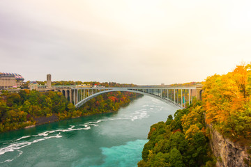 Rainbow Bridge at Niagara Falls during sunrise .