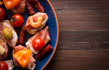 Spanish tapas starters on wooden table