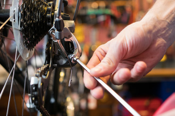 Guy fixing bicycle in garage