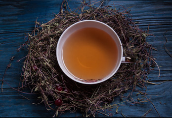 Top view of cup of tea on vintage wooden background.