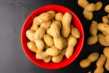 Peanuts in shell on dark background, close up