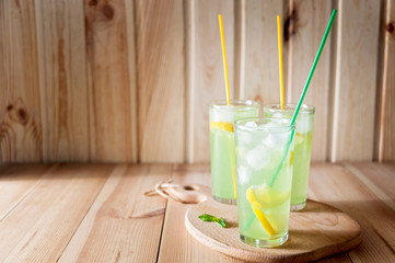 lemonade in jar with fresh lemon sliced and sprig of mint