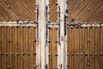 ancient brown wooden door with metallic ornaments