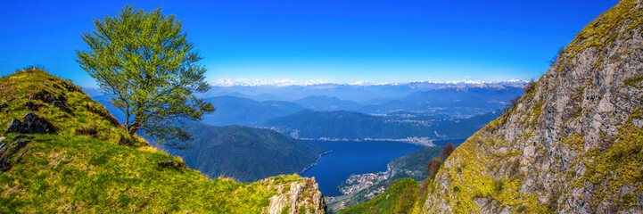 Fototapeta na wymiar View to Lugano city, San Salvatore mountain and Lugano lake from Monte Generoso