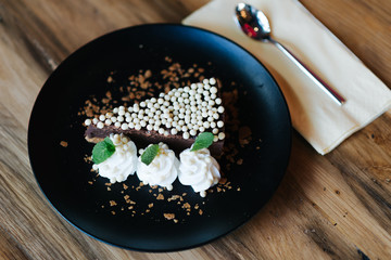 Chocolate tart on the old rustic table.