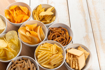 Pretzels in bowls on wooden table from above