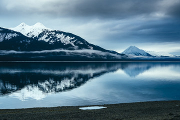 Calm Alaska Inlet with Distant Mountains and Reflection 