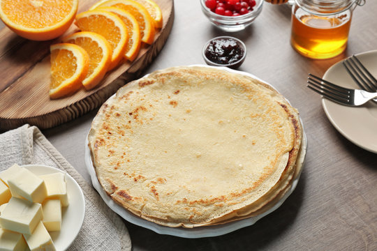 Delicious pancakes and ingredients for filling on table