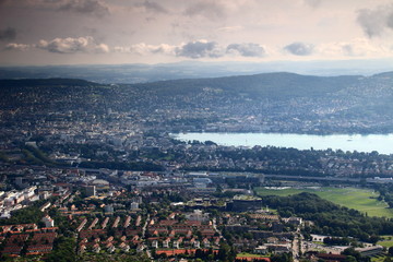 Cityscape of Zurich, the colorful rooftops of the city centre with Lake Zurich and forested Adlisberg, seen from Uetliberg, Switzerland, Europe