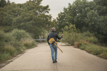 Man with guitar in the field