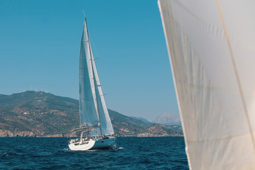 Obraz premium Sailboats during a cruise in the Aegean sea. Luxury yachts, marine tourism.