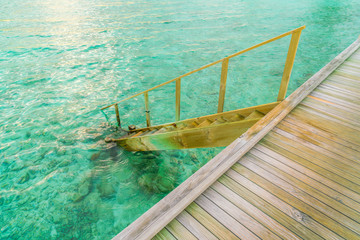 Wood stair into the sea of tropical Maldives island .