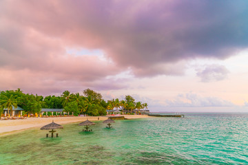 Beautiful sunset with sky over calm sea  in tropical Maldives island .
