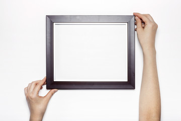 woman hand hold a photo frame isolated white.