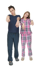 Fototapeta premium Young sleepy couple suffering from somnambulism on white background