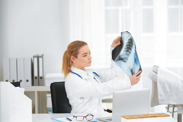 Beautiful young orthopedist working in office