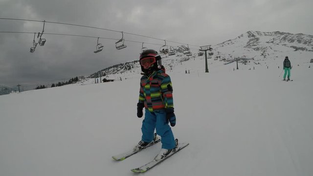 Little boy skiing in the Alps.
Son when skiing. They learn to ski with their parents.
