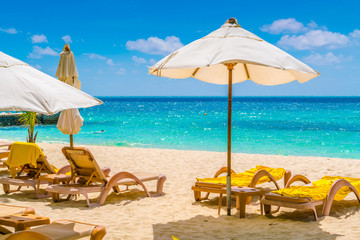 Beach chairs with umbrella at Maldives island, white sandy beach and sea .