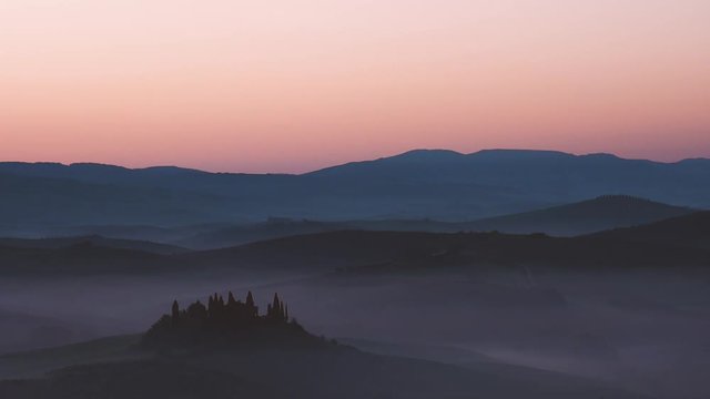 Panoramic video of a landscape of the Tuscan hills during sunrise with fog in the Val d'Orcia