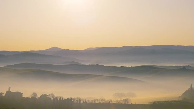 Panoramic video of a landscape of the Tuscan hills during sunrise with fog in the Val d'Orcia