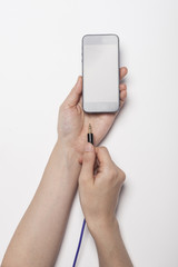 woman hand hold a power plug isolated white