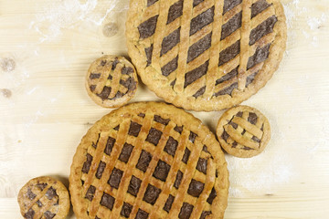 Tart with chocolate cream on wooden background - top view