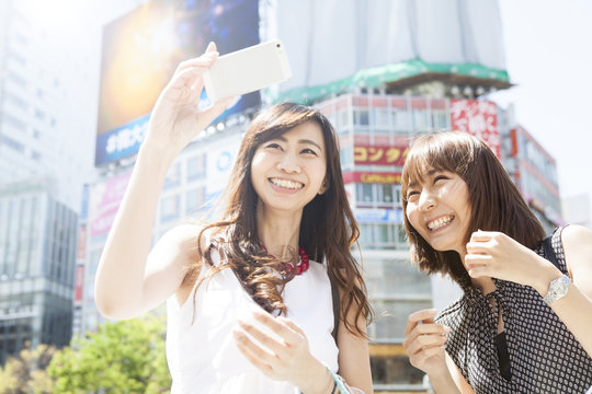 Two young ladies are shooting at Shibuya