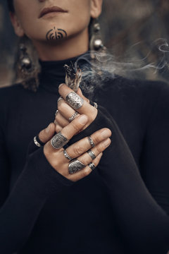 close up of young woman hands holding incense