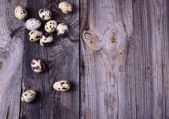 quail eggs on a gray wooden surface
