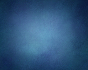abstract solid background in dark blue color hues with soft lighting and vintage grunge textured vignette border