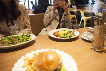 Women are shooting lunch with a smartphone
