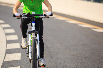 one woman cycling mountain bike on road