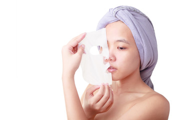 Beauty skin care cosmetics and health concept. Closeup Asian young woman face, girl removing facial peel off mask isolated on white color background with clipping path.
