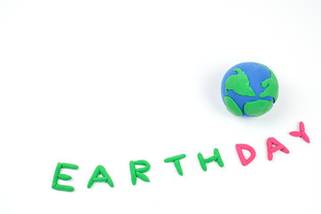 Globe ,earth made from clay and letter earth day on white background.Concept Save green planet. Earth day holiday concept