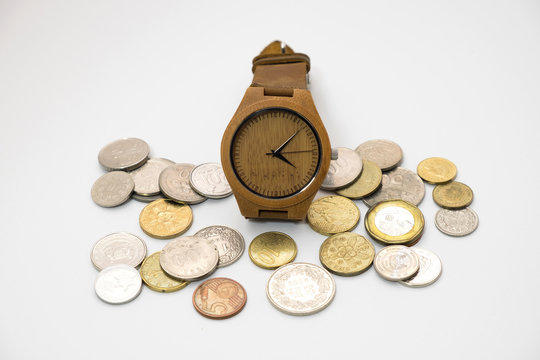 wooden watch putting on various sizes coin stack with white background,this image for money saving and retro concept