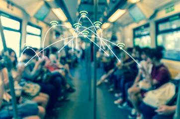 Abstract blurred photo of passengers who are using the smart phone or tablet for social network in sky train,connection and social network concept