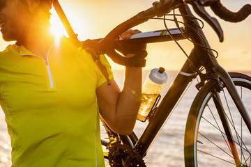 Cyclist tourist taking selfie picture with smartphone during biking trip alone on summer vacation...