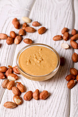Peanut cream in a bowl close up on the table.