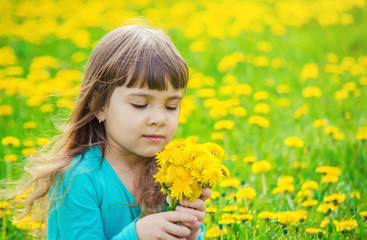 Girl, child, flowers in the spring plays. Selective focus. 