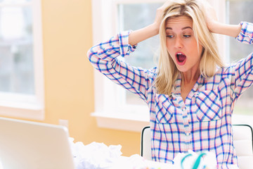 Young woman with crumpled paper balls